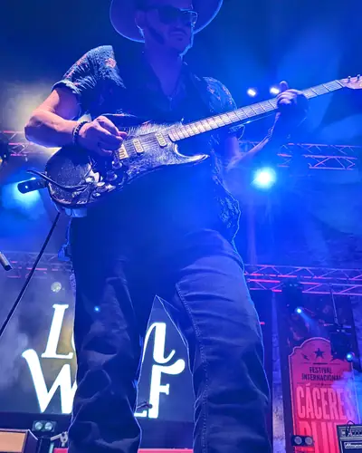 LeanWolf con su guitarra bajo luz azul